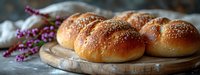 Fresh homemade buns with sesame seeds on wooden cutting board, rustic setting with purple flowers, warm golden crust, food photography in natural light.