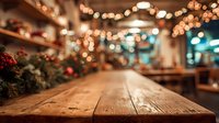 Rustic wooden table in cozy restaurant with festive Christmas decorations and warm bokeh lights creating holiday atmosphere.