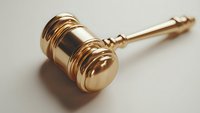 Golden judge gavel on neutral background, symbol of law, justice and authority in legal proceedings and court decisions. Professional studio lighting.