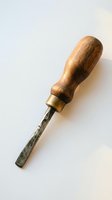 Vintage wood handle chisel with metal blade on white background for woodworking crafts and carpentry projects.