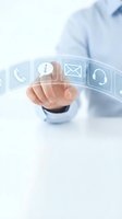 Businessman hand touching virtual communication icons including phone, email, and headset for customer service and digital contact solutions.