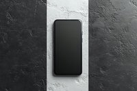 Modern smartphone with blank black screen on contrasting black and white textured concrete background, top view mockup for app and web design presentation.