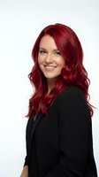 Professional businesswoman with vibrant red hair smiling confidently in black blazer isolated on white background for corporate and business use.