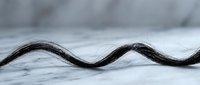Abstract flowing black wave pattern on white marble surface creating elegant minimalist design for modern interior decoration and graphic projects.