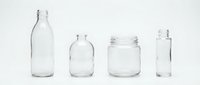 Empty clear glass containers collection including bottles and jars isolated on white background for packaging design and product mockups.