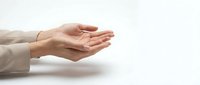 Caucasian woman's hands in open palm gesture against white background, suitable for business, healthcare, charity, and support concepts.