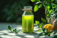 Fresh green smoothie or juice in glass bottle with citrus and herbs on wooden table in natural sunlight, healthy detox beverage for wellness lifestyle.