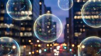 Transparent soap bubbles floating against blurred city lights at night creating magical urban atmosphere for creative projects and designs.