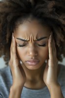 Young African American woman experiencing severe headache holding temples with closed eyes showing pain and stress symptoms for health awareness campaigns.