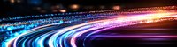 Vibrant light trails create dynamic motion effect with blue, pink and orange streaks against dark background, abstract long exposure photography for technology concept.