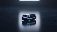 Modern black USB flash drive with blue LED light displaying innovations text on dark reflective surface for technology and data storage concepts.