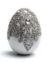 Luxury white decorative egg adorned with intricate silver rhinestone patterns and crystal embellishments for elegant home decor and special occasions.
