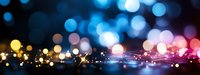 Abstract bokeh lights background with colorful glowing circles in blue pink and golden tones creating dreamy atmosphere for presentations banners.