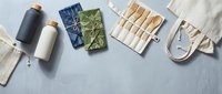 Eco-friendly sustainable lifestyle flat lay with reusable bamboo utensils, organic cotton pouches, and zero waste containers on neutral background for conscious living.