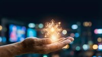 Hand holding glowing dollar sign with digital network connections against blurred city lights background representing financial technology and investment.