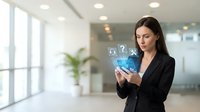 Professional businesswoman using smartphone with digital icons in modern office environment for technology and communication concepts.