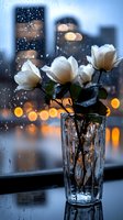 White roses in crystal vase against rainy window with city lights bokeh background creating cozy atmospheric mood for romantic or contemplative designs.