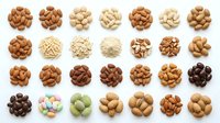 Assorted nuts and legumes collection including almonds, cashews, peanuts, chickpeas, and beans in various roasted shades, isolated on white background for food packaging and culinary design.