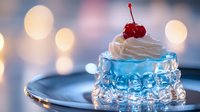 Creamy dessert topped with maraschino cherry in elegant blue glass bowl against soft bokeh background, perfect for food service advertising.
