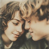 Young couple in intimate moment sharing tender gaze with warm lighting. Romance, love, relationship concept for dating apps, wedding invitations, greeting cards.