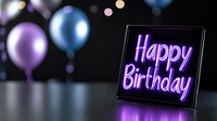 Glowing neon happy birthday sign with purple and blue balloons on dark background creates festive party atmosphere for celebration designs.