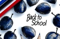 Dark blue plums arranged around handwritten "Back to School" text with red and blue pencils on white background, creating educational composition.