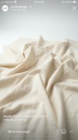 Crumpled muslin fabric in natural beige tones with soft folds and wrinkles, suitable for textile, fashion, and design backgrounds.