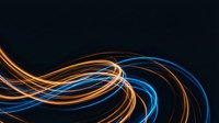 Abstract flowing light trails in blue and orange colors creating dynamic wave patterns on dark background for modern digital design projects.