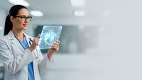 Female Asian doctor examining digital brain scan on tablet in modern medical facility for neurological diagnosis and healthcare technology applications.