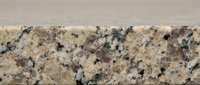 Natural granite stone surface with speckled pattern in beige, gray and brown tones for countertops, flooring and architectural design projects.