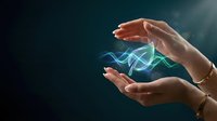 Female hands protecting glowing blue and green energy waves on dark background representing innovation, technology protection and digital transformation.