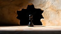 Black chess pawn casting shadow on light surface with dramatic lighting and dark background, symbolizing strategy, leadership potential and personal growth in business.