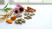 Natural herbal supplements and echinacea flowers arranged on white surface for alternative medicine and wellness lifestyle concepts.