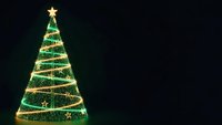 Glowing Christmas tree with golden lights and star on dark background for holiday greeting cards and festive decorations.