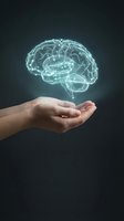 Human hand holding a glowing holographic brain with neural connections on dark background, symbolizing AI, neuroscience, and mental health concepts.