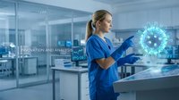 Female scientist in blue lab coat analyzing digital virus model with holographic technology in modern laboratory for medical research and innovation.