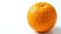 Fresh ripe orange with water drops isolated on white background, vibrant citrus fruit with dew for healthy food and nutrition design.