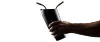 Hand holding a dark reusable cup with two straws against white background, dramatic silhouette lighting for beverage and lifestyle concepts.