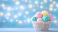 Colorful yarn balls in white wicker basket against blurred blue bokeh background. Soft pastel pink, turquoise and yellow wool skeins for knitting and crafts.