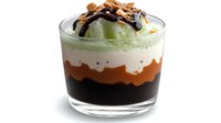 Layered dessert with green matcha cream, caramel and chocolate sauce topped with nuts in glass cup on white background for cafe menu design.