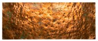 Hammered copper metal surface with warm golden-brown patina and textured dimpled finish, suitable for backgrounds, design elements, and industrial aesthetic projects.