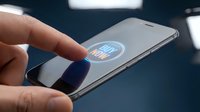 Hand pressing glowing buy now button on smartphone screen, online shopping and mobile commerce concept.