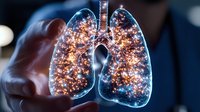 Glowing anatomical lungs with sparkling light effects held in hands against dark background, medical science visualization for respiratory health and pulmonology concepts.