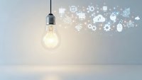 Glowing light bulb with digital technology icons floating around representing innovation, creativity, and smart solutions for business concepts.