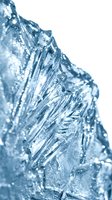 Macro close-up of crystalline ice formations with sharp geometric structures and frozen water droplets, isolated on white background for design use.