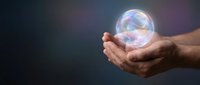 Hands holding glowing translucent sphere with rainbow reflections against dark gradient background. Concept for protection, care, innovation and future.