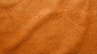 Tan leather texture with natural grain and wrinkles, suitable for backgrounds, design projects, fashion, upholstery, and material mockups.