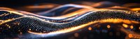Abstract digital wave of golden and blue particles flowing with light effects on dark background for technology and data visualization concepts.