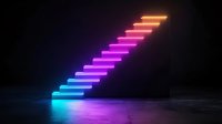 Glowing neon staircase with vibrant gradient colors from blue to pink and orange against dark background, creating futuristic atmosphere on concrete floor.