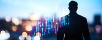 Silhouette of businessman analyzing financial market data and glowing trading charts against blurred city lights and bokeh background at dusk.